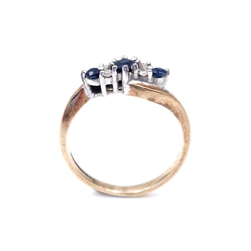 48 - Star Lot : A vintage three stone sapphire and diamond twist set mount ring set in nine carat gold (M... 