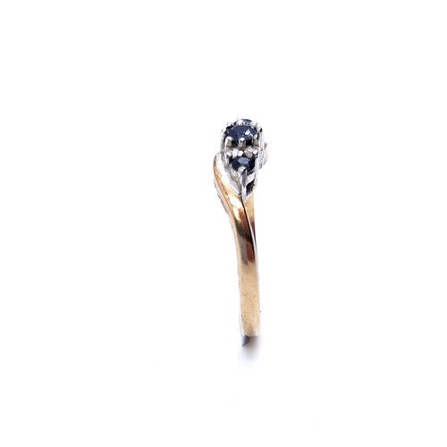 48 - Star Lot : A vintage three stone sapphire and diamond twist set mount ring set in nine carat gold (M... 