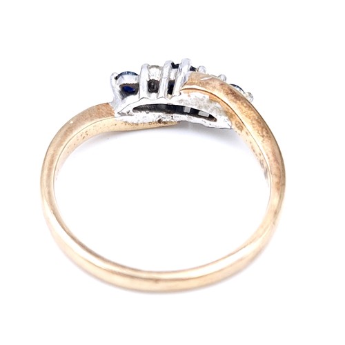 48 - Star Lot : A vintage three stone sapphire and diamond twist set mount ring set in nine carat gold (M... 