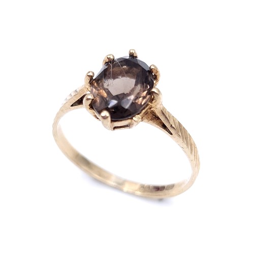 49 - A smoky quartz stone ring with claw set mount set in nine carat gold (375). Ring size - H. Weight - ... 