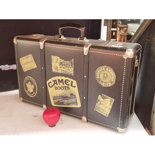 1067 - A vintage style suitcase with retro travel and advertising stickers. Previous in auction 18/08 lot 3... 