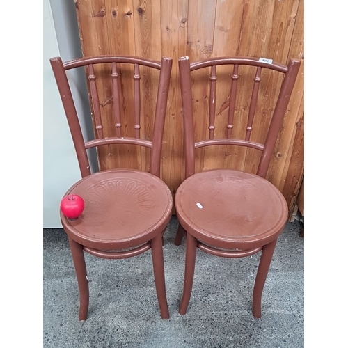 1089 - A Pair of Polish made wooden bentwood bistro chairs featuring detailed embossed seat designs. They a... 