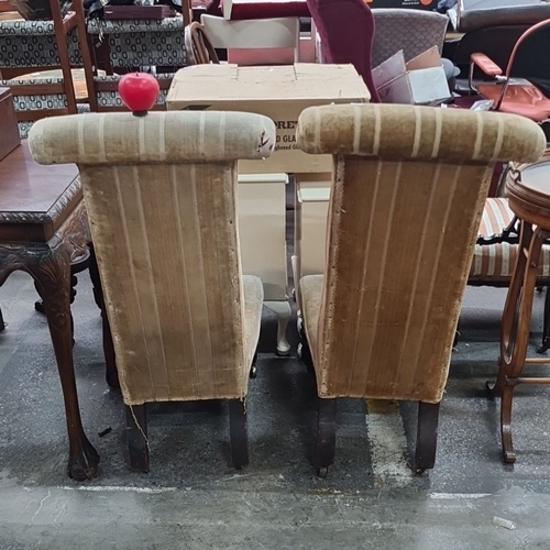 1092 - Star Lot : A great Pair of early 20th-century upholstered high-back chairs with turned wood legs. Th... 