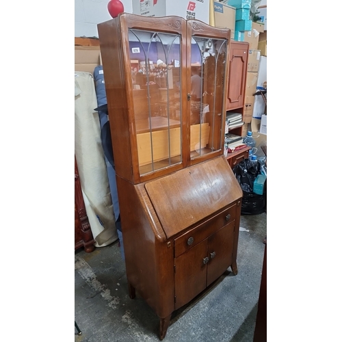 1097 - A 1940s bureau bookcase with desk and  glass display cabinet. It features leaded glass doors over a ... 