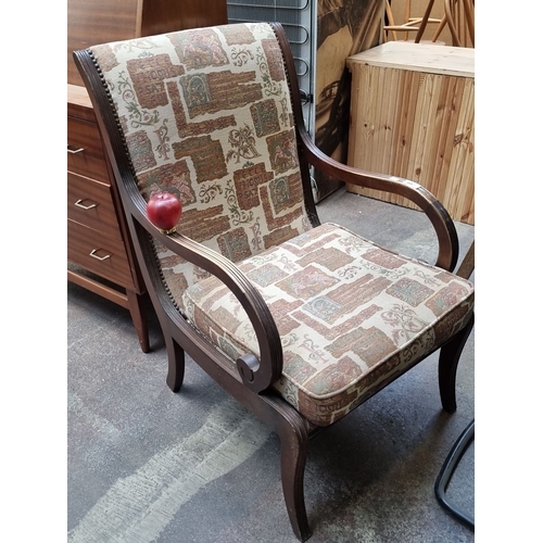 1113 - A lovely mid century armchair with curved wooden armrests and a tapestry fabric upholstery in earthy... 