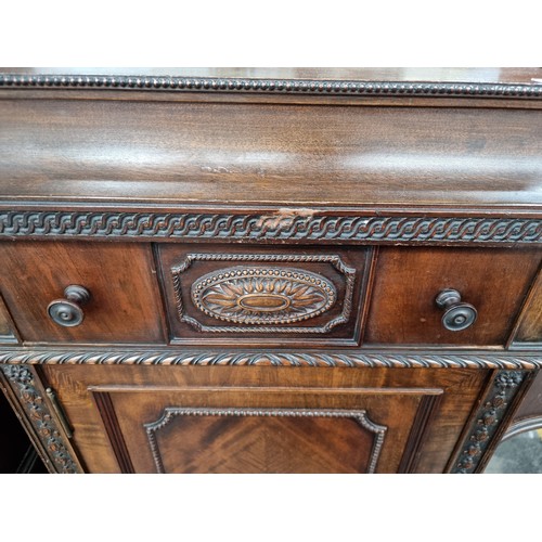 1118 - Star Lot : A stunning Sheraton large sideboard boasting intricate carvings and multiple drawers. The... 