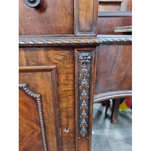 1118 - Star Lot : A stunning Sheraton large sideboard boasting intricate carvings and multiple drawers. The... 