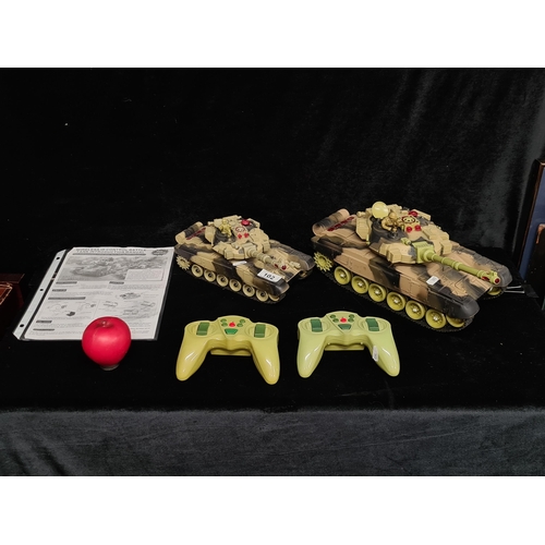 102 - Two wireless IR control battle tanks complete with remote controls and instruction manual.