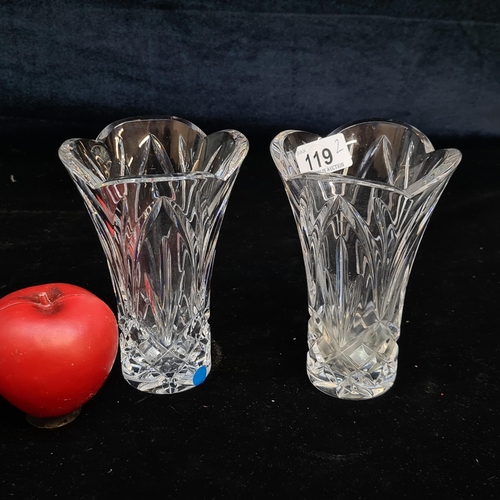 119 - A pair of Waterford Crystal vases featuring scalloped rim and intricately cut motifs.