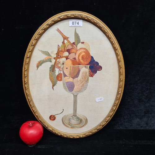 74 - A charming needlepoint tapestry. Features a still life study of fruits in a wine glass. Rendered in ... 