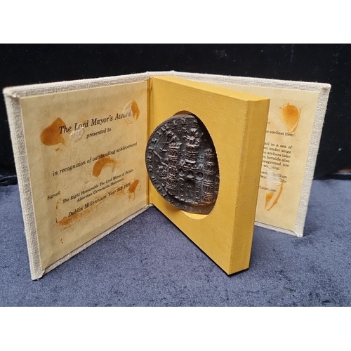 The Lord Mayor's Award with commemorative double sided swivel Dublin seal, Dublin Millennium Year 988–1988, for Alderman Carmencita Hederman. Linen-bound presentation display. Possibly bronze, nice weight and rare piece.