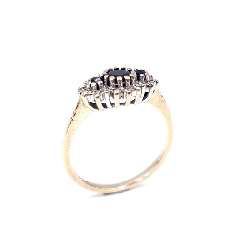 10 - A sapphire and diamond cluster ring mounted in nine carat gold. Weight - 2.5 grams. Size - O.