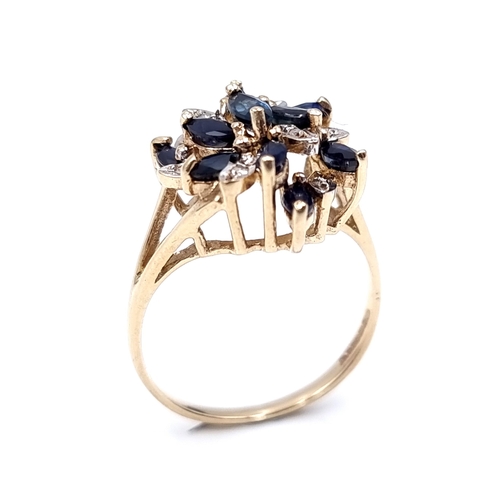 13 - A nine carat gold swirl design sapphire and diamond statement ring. Size - N. Weight - 3.15 grams.