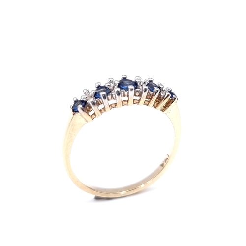 14 - Star Lot : A nine carat gold five stone sapphire & diamond ring. Size - N. Weight - 1.98 grams.