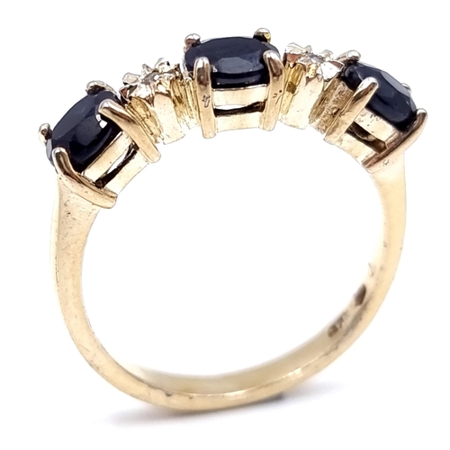 2 - Star Lot : A three stone diamond and sapphire ring set in nine carat gold. Size - N 1/2. Weight - 2.... 