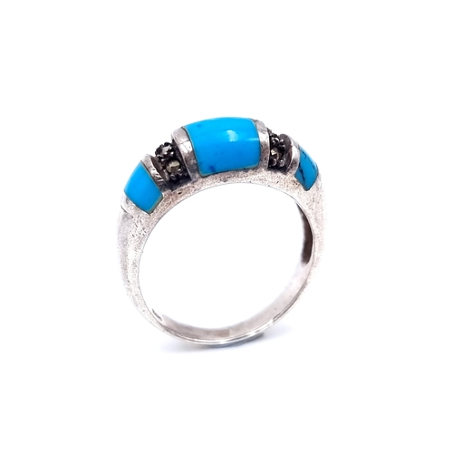 22 - A sterling silver turquoise and marcasite set ring. Size - N. Weight - 3.52 grams.