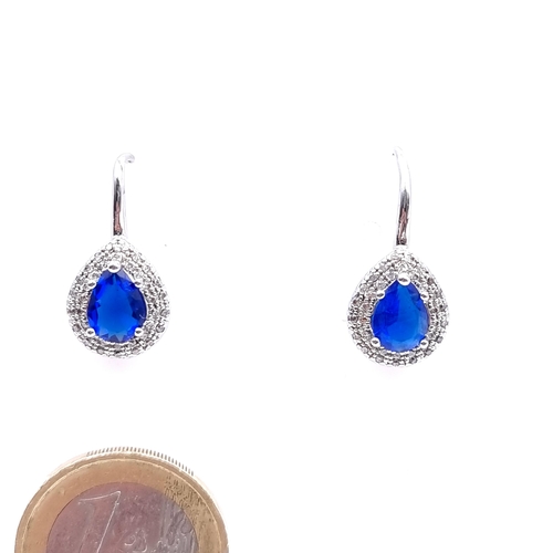 23 - A pair of 925 teardrop blue gemstone earrings with gem set surround - suitable for pierced ears.