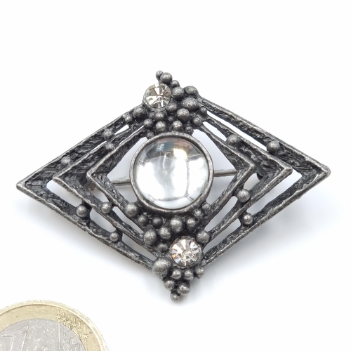 30 - A vintage art deco style brooch. Length - 5 x 4 cms. Set with gemstone detailing. Weight - 12.14 gra... 