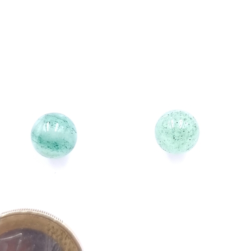 35 - A pair of 14 carat circular jade stone stud earrings. Weight - 2 grams.