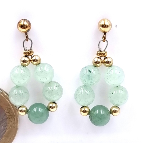 36 - A pair of multi-stone 14 carat gold jade stud earrings. Weight - 3.84 grams. A most unusual and attr... 