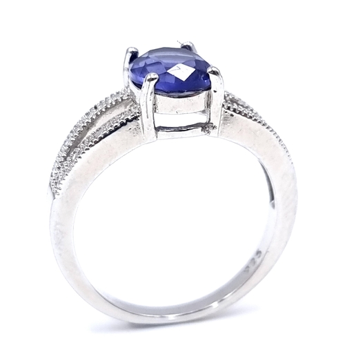 37 - A pretty sterling silver Tanzanite stone gem set ring. Size - U. Weight - 4.62 grams.