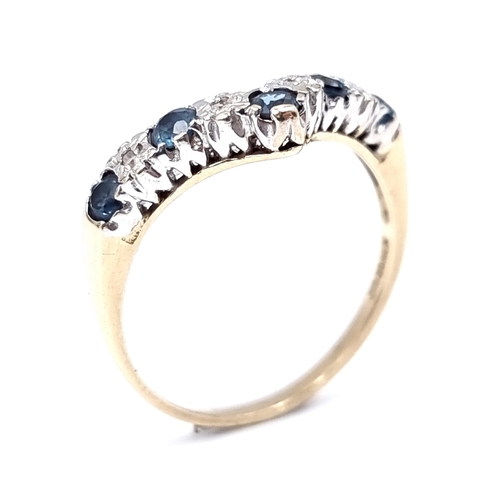 8 - Star Lot : A nine carat gold sapphire and gem set wishbone ring. Size - L 1/2. Weight - 1.8 grams.