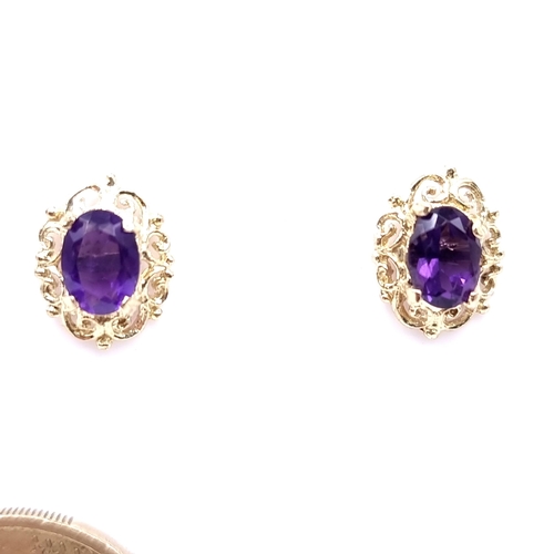 9 - A pair of vintage nine carat gold amethyst stone stud earrings. Weight - 1.65 grams.