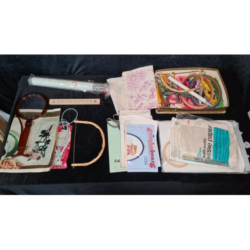 922 - A box containing an assortment of sewing and patch work accessories including thread and needles.