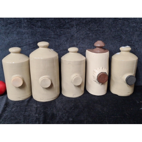 926 - Five antique stoneware hot water bottles.