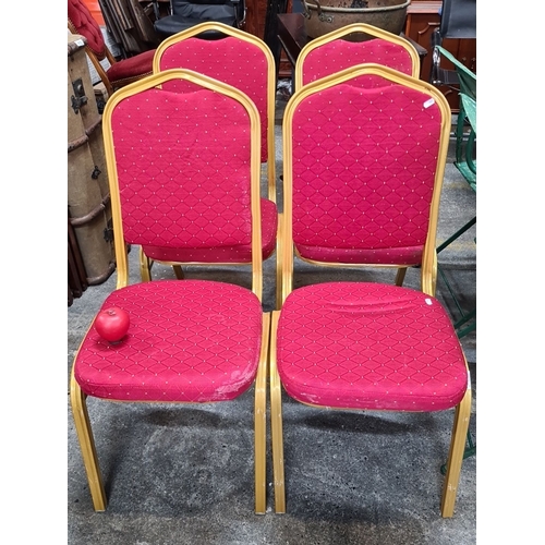 1244 - Set of four red upholstered stackable chairs with gold-tone metal frames. Each chair features a diam... 