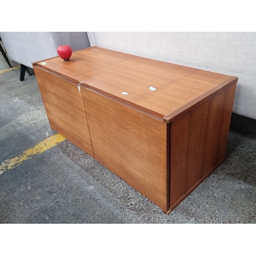 1251 - Mid-Century Modern teak storage cabinet features a drop-down front door and a spacious interior. The... 