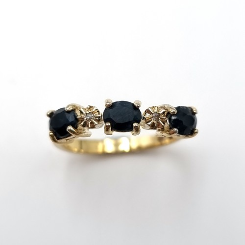 2 - Star Lot : A three stone diamond and sapphire ring set in nine carat gold. Size - N 1/2. Weight - 2.... 