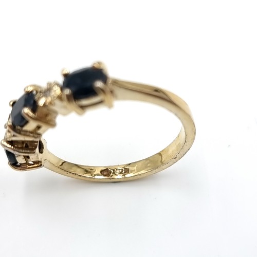 2 - Star Lot : A three stone diamond and sapphire ring set in nine carat gold. Size - N 1/2. Weight - 2.... 