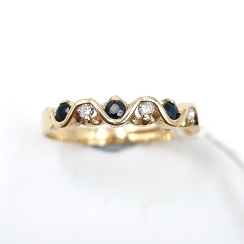 6 - Star Lot : A diamond and sapphire twist set mounted ring in nine carat gold. Size - M 1/2. Weight - ... 