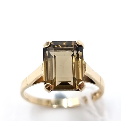 7 - Star Lot : A nine carat gold smoky quartz claw set ring. Size - M 1/2. Weight - 2.4 grams.