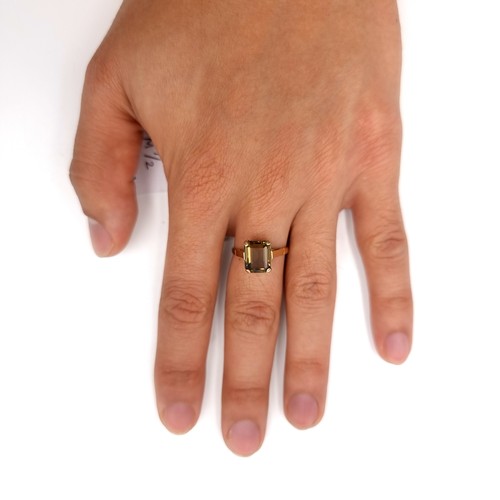 7 - Star Lot : A nine carat gold smoky quartz claw set ring. Size - M 1/2. Weight - 2.4 grams.