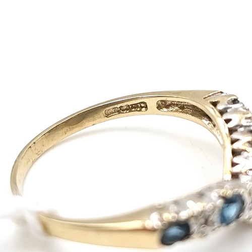 8 - Star Lot : A nine carat gold sapphire and gem set wishbone ring. Size - L 1/2. Weight - 1.8 grams.