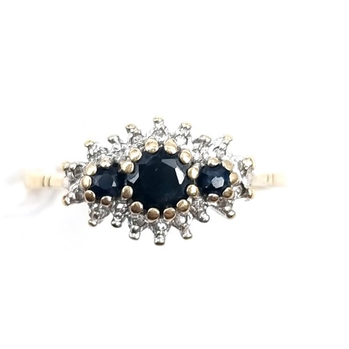 10 - A sapphire and diamond cluster ring mounted in nine carat gold. Weight - 2.5 grams. Size - O.