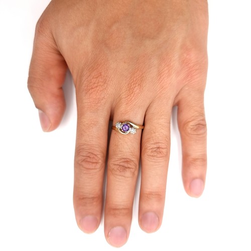 12 - Star Lot : A nine carat gold amethyst and diamond ring with twist circle mount. Size - O. Weight - 2... 