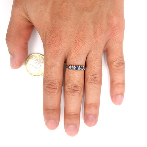 14 - Star Lot : A nine carat gold five stone sapphire & diamond ring. Size - N. Weight - 1.98 grams.