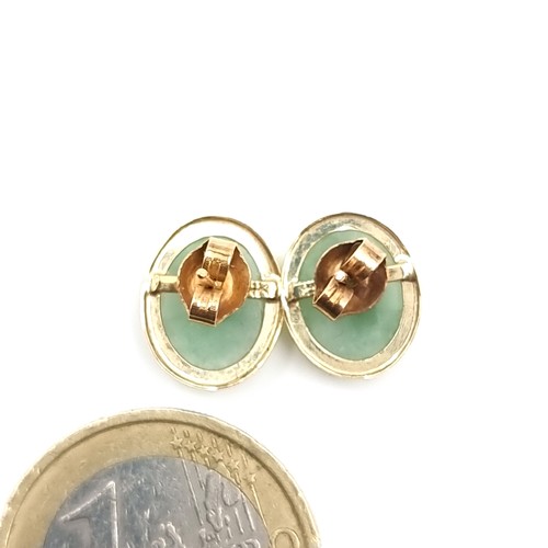 34 - A good pair of 14 carat gold jade stud earrings. Weight - 1.66 grams.