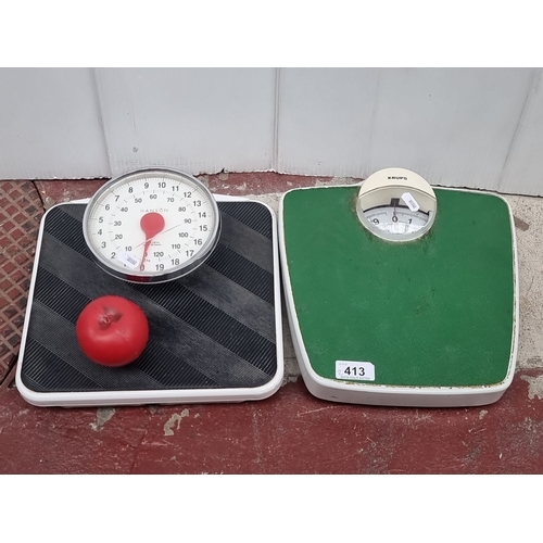 413 - Pair of vintage analogue bathroom scales: Hanson in black with red accents, and Krups in green and w... 