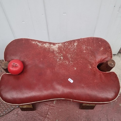 415 - Vintage red leather upholstered footstool with detailed wooden inlay. Features intricate geometric p... 