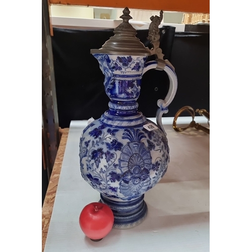 426 - Antique ceramic German ewer with pewter lid, featuring intricate blue and white floral patterns, fro... 