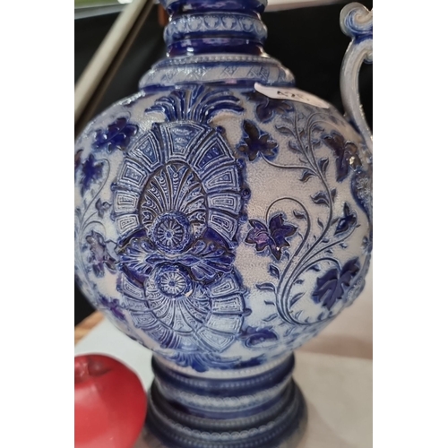 426 - Antique ceramic German ewer with pewter lid, featuring intricate blue and white floral patterns, fro... 