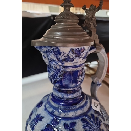 426 - Antique ceramic German ewer with pewter lid, featuring intricate blue and white floral patterns, fro... 