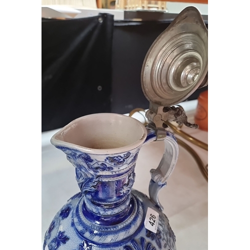 426 - Antique ceramic German ewer with pewter lid, featuring intricate blue and white floral patterns, fro... 