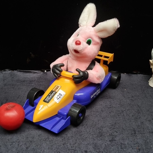 428 - Promotional large toy featuring a pink bunny in a blue and yellow racecar, branded with 