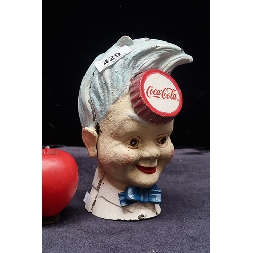 429 - Vintage heavy cast iron bank shaped like a boy's head, hand-painted with blue hair and red lips, fea... 