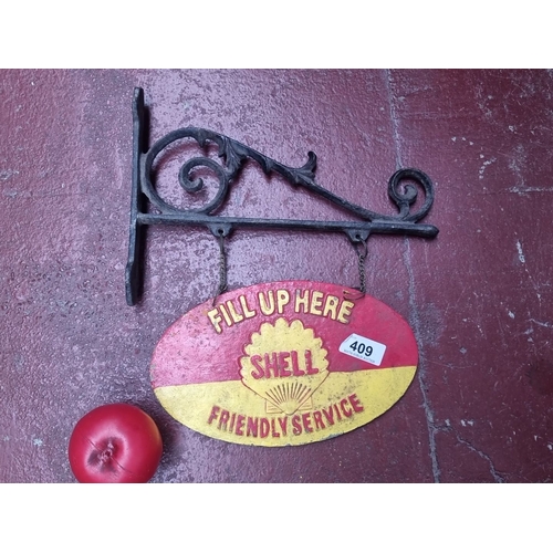 409 - Vintage Shell Friendly Service sign with wrought iron bracket, featuring the iconic red and yellow S... 